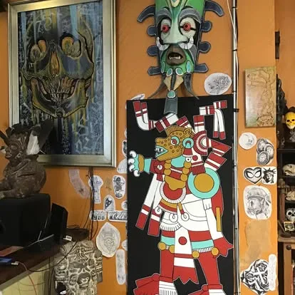 Inside La Familia: art-covered walls, masks and an Aztec-style painted figure