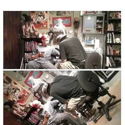 Artists tattooing in the shop
